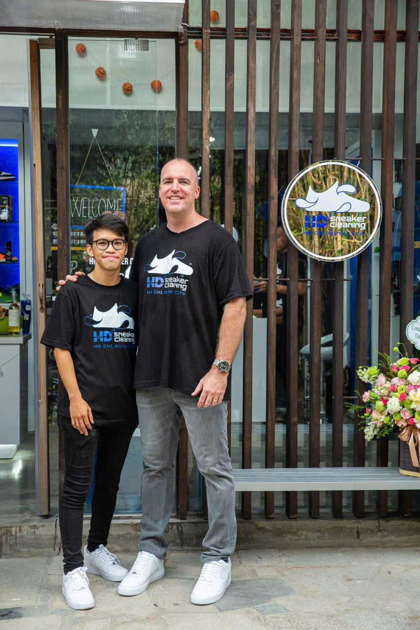Derek with a young founder outside the HD Sneaker Cleaning store in Ho Chi Minh City